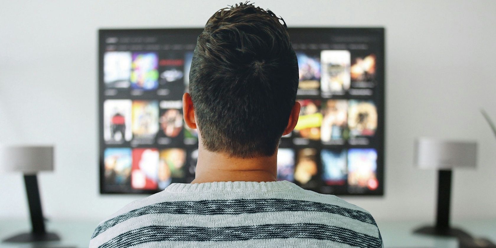 man watching tv from living room