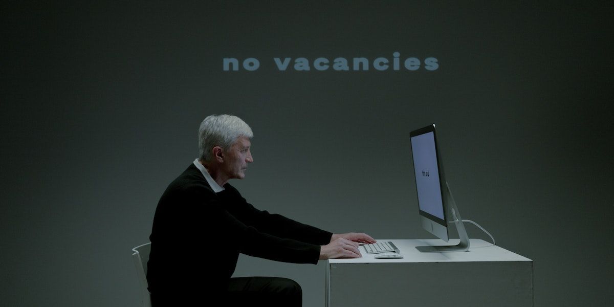 man using pc no vacancies in background