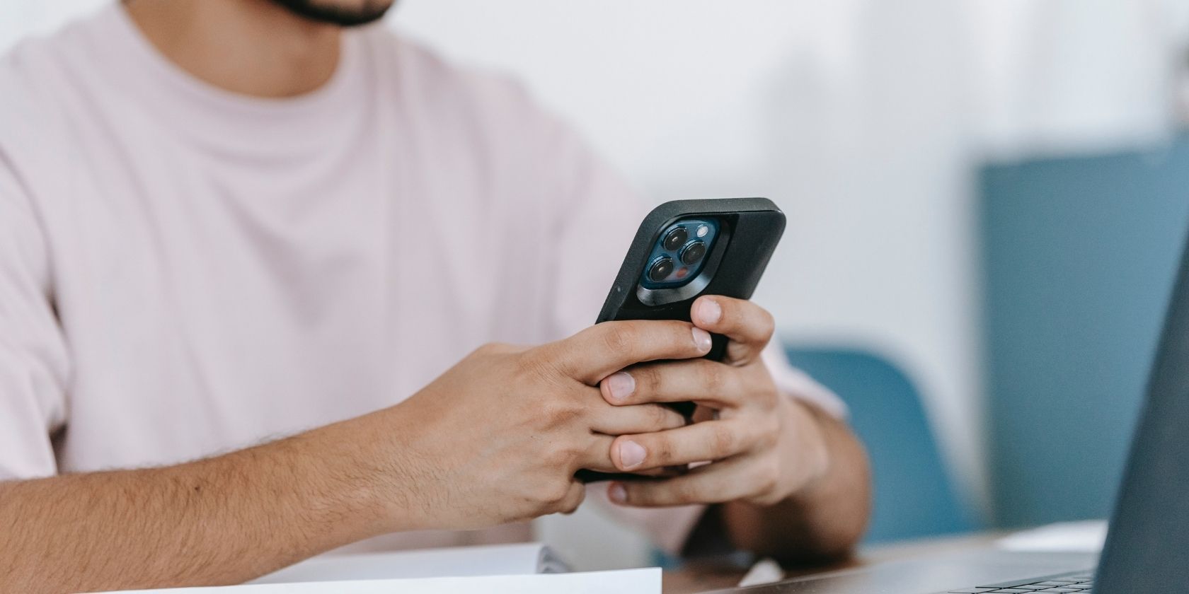man using phone at desk