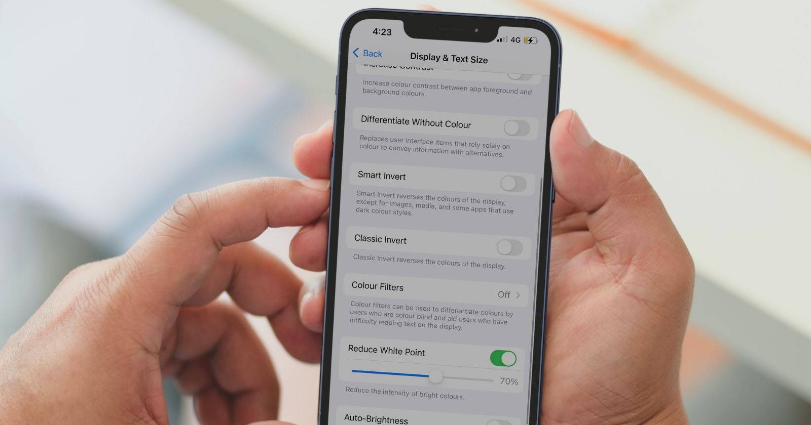 hand holding iphone with dimmed screen
