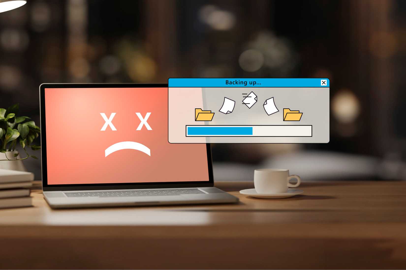«Мёртвый» ноутбук с окном резервного копирования на переднем плане