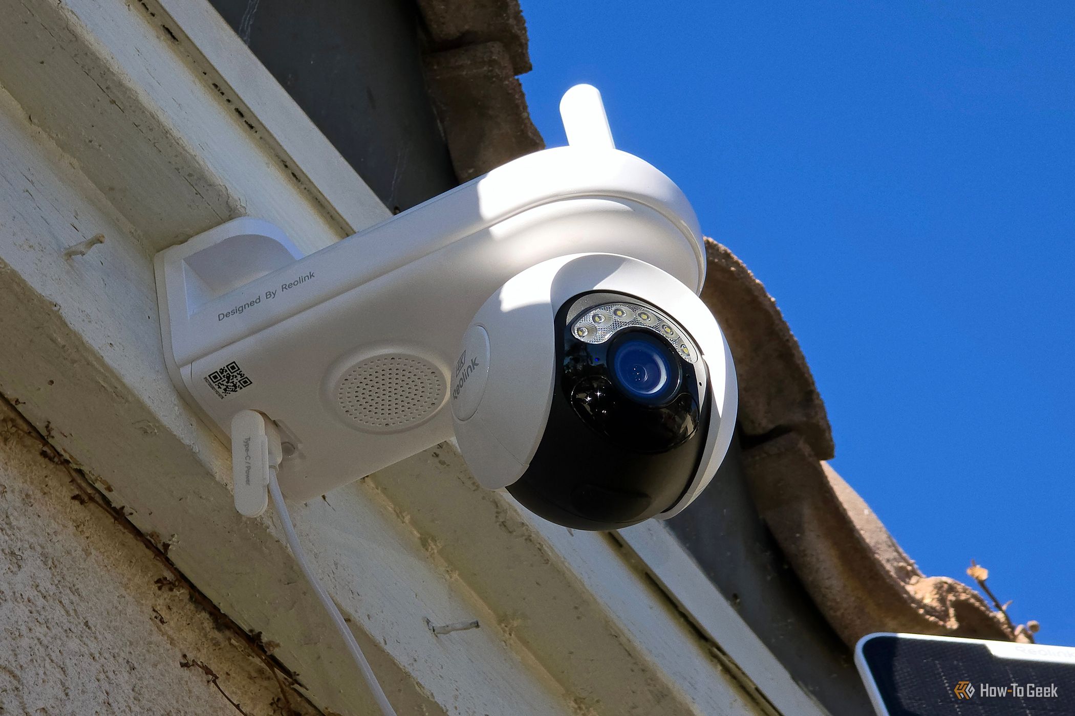 The Reolink Atlas PT Ultra security camera on the front of a house.