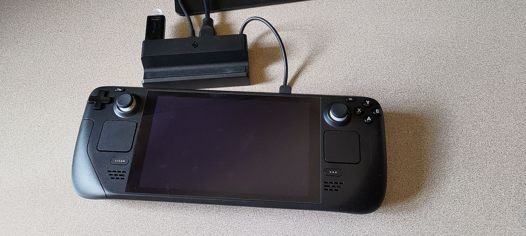 Steam Deck подключён к официальной док-станции, к нему подсоединена USB-флешка.