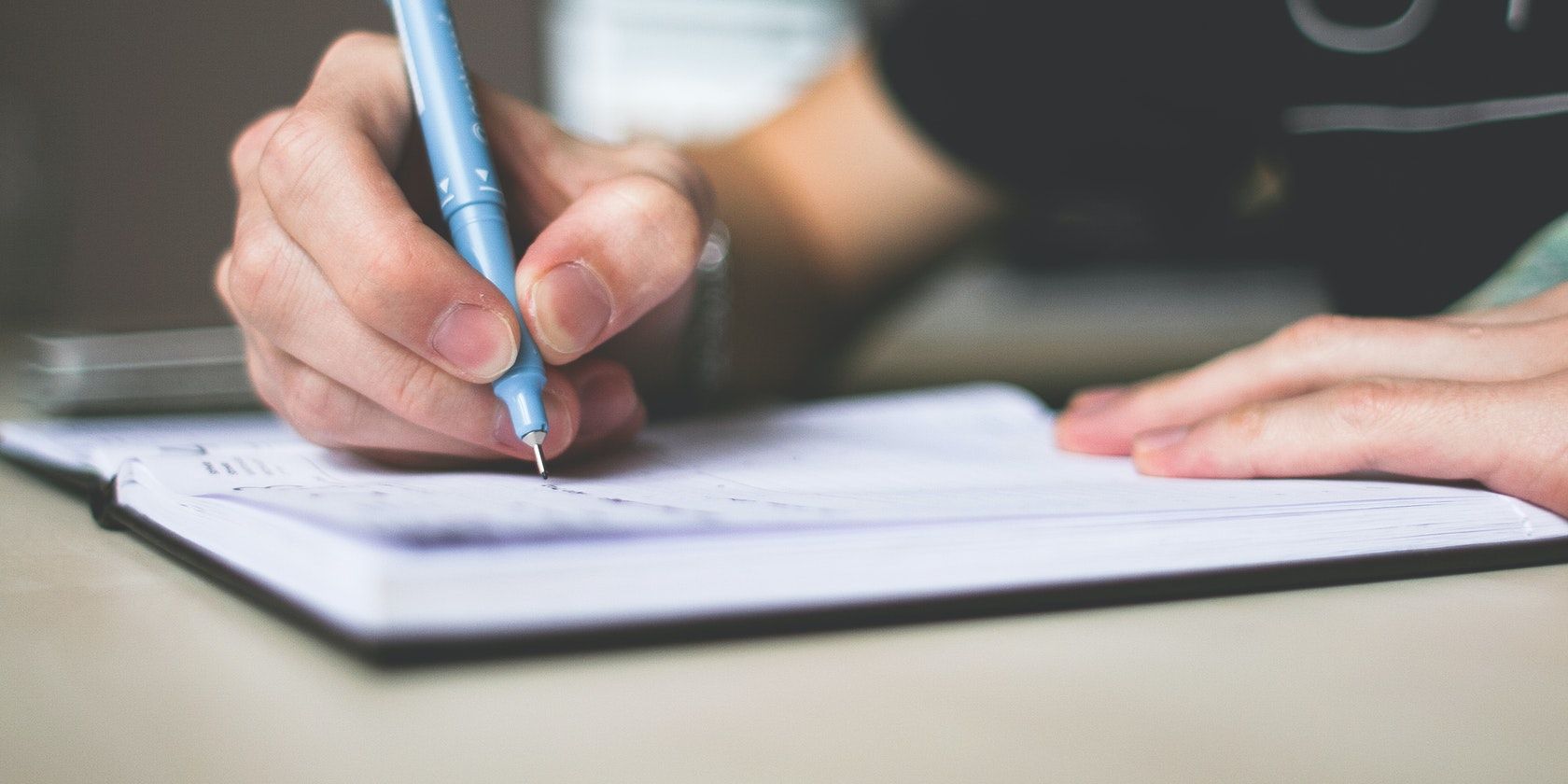 Человек пишет от руки список задач