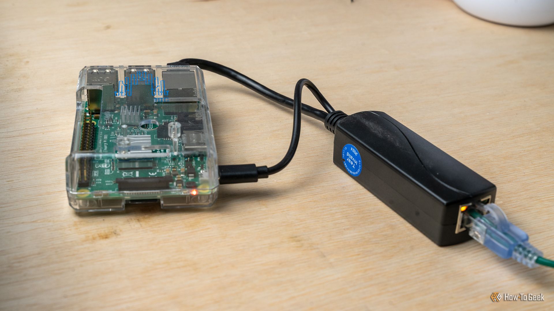 A Power over Ethernet splitter plugged into a Raspberry Pi 3B.