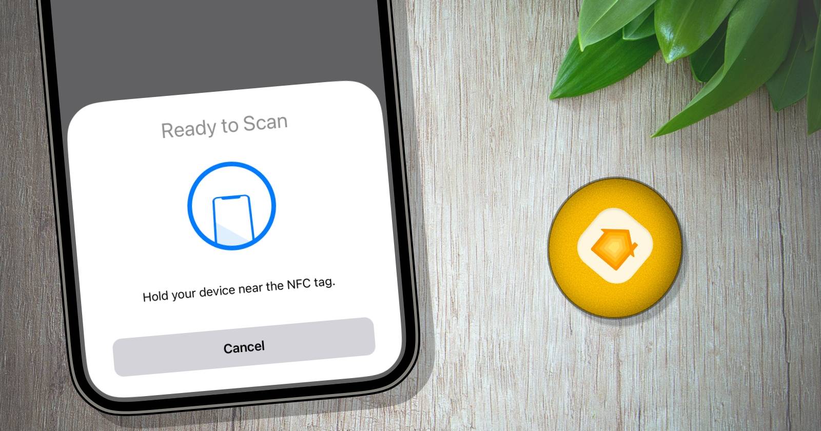 iPhone с подсказкой сканирования рядом с оранжевой NFC-меткой на деревянной поверхности