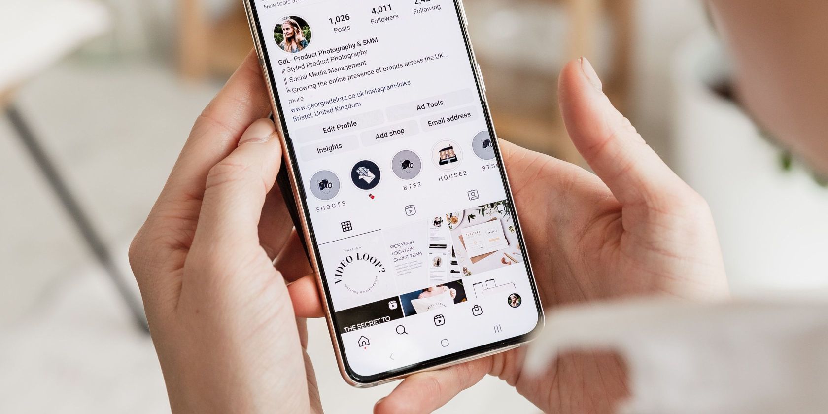 person looking at an instagram account on their smartphone