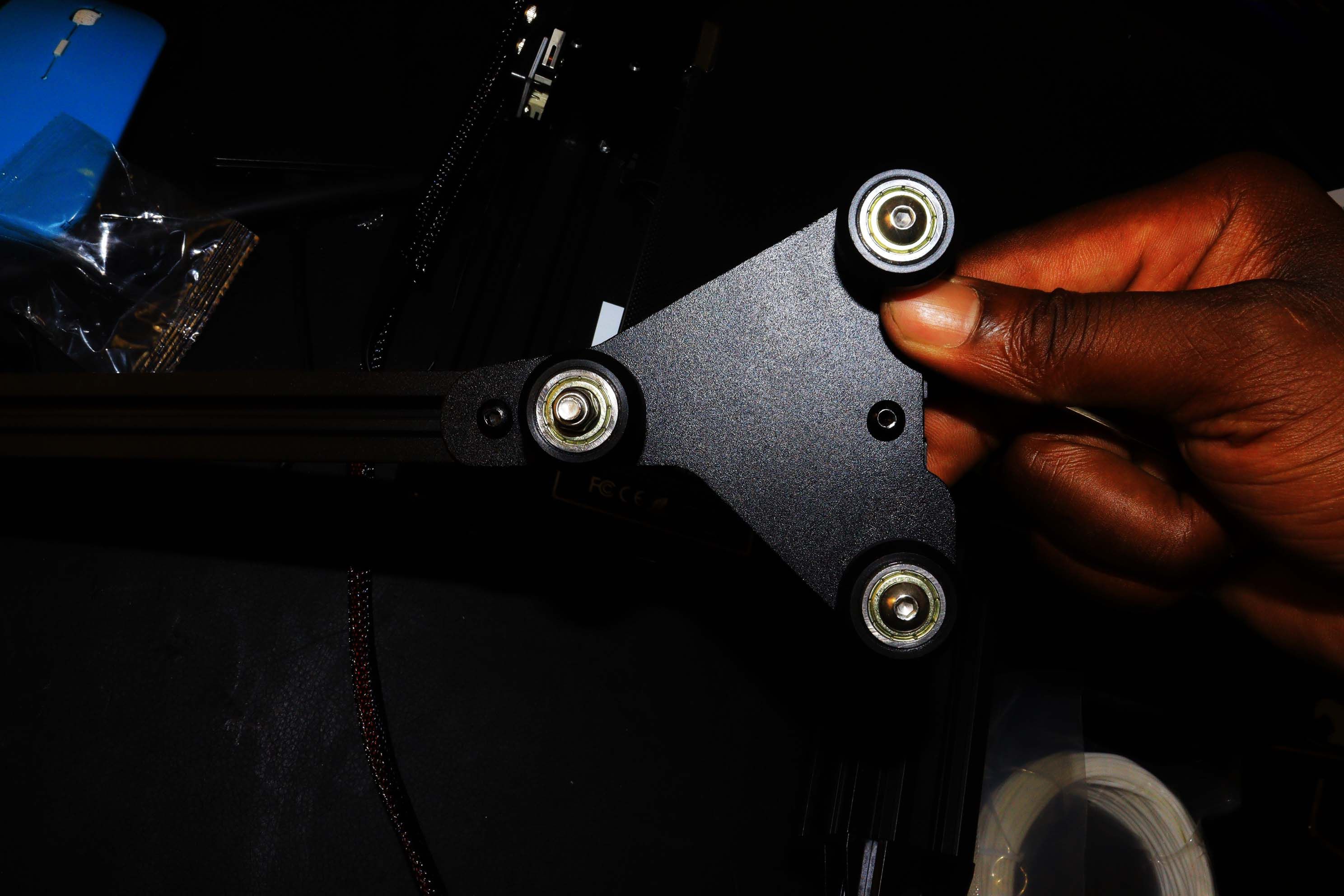 A hand inserting the z-axis to the passive block