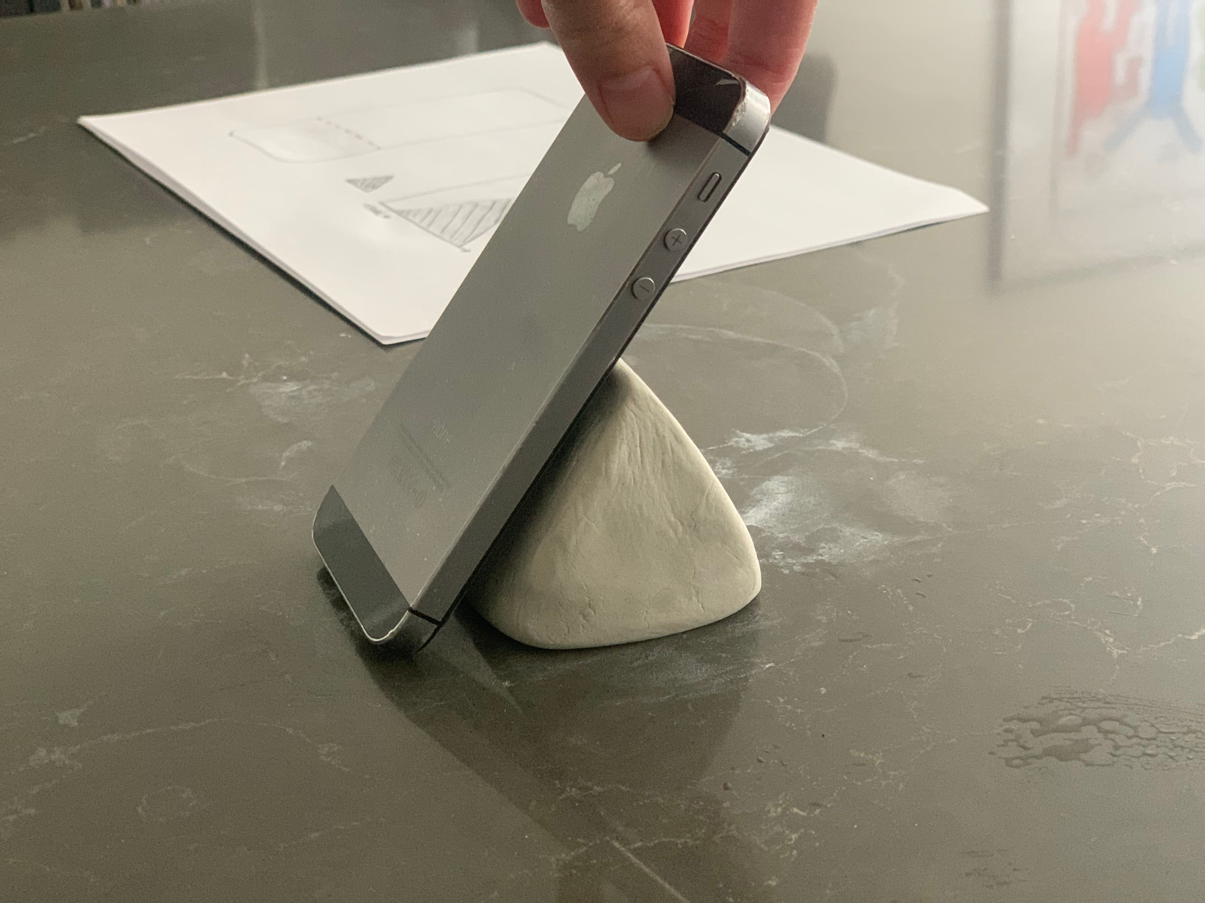 iPhone 6s опирается о треугольник из глины