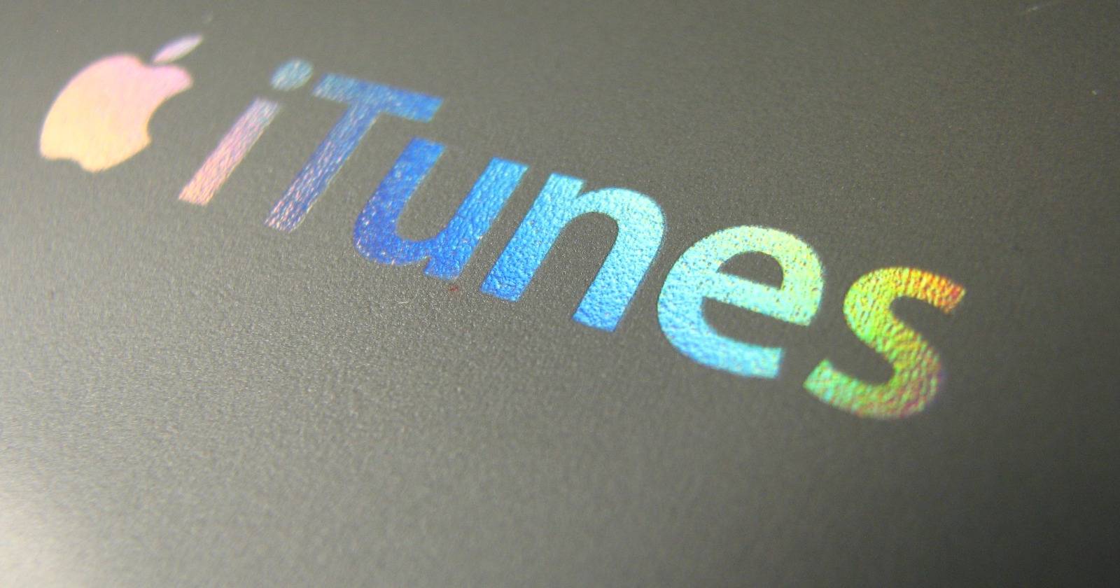 Обложка: логотип iTunes и значок Microsoft Store на экране компьютера