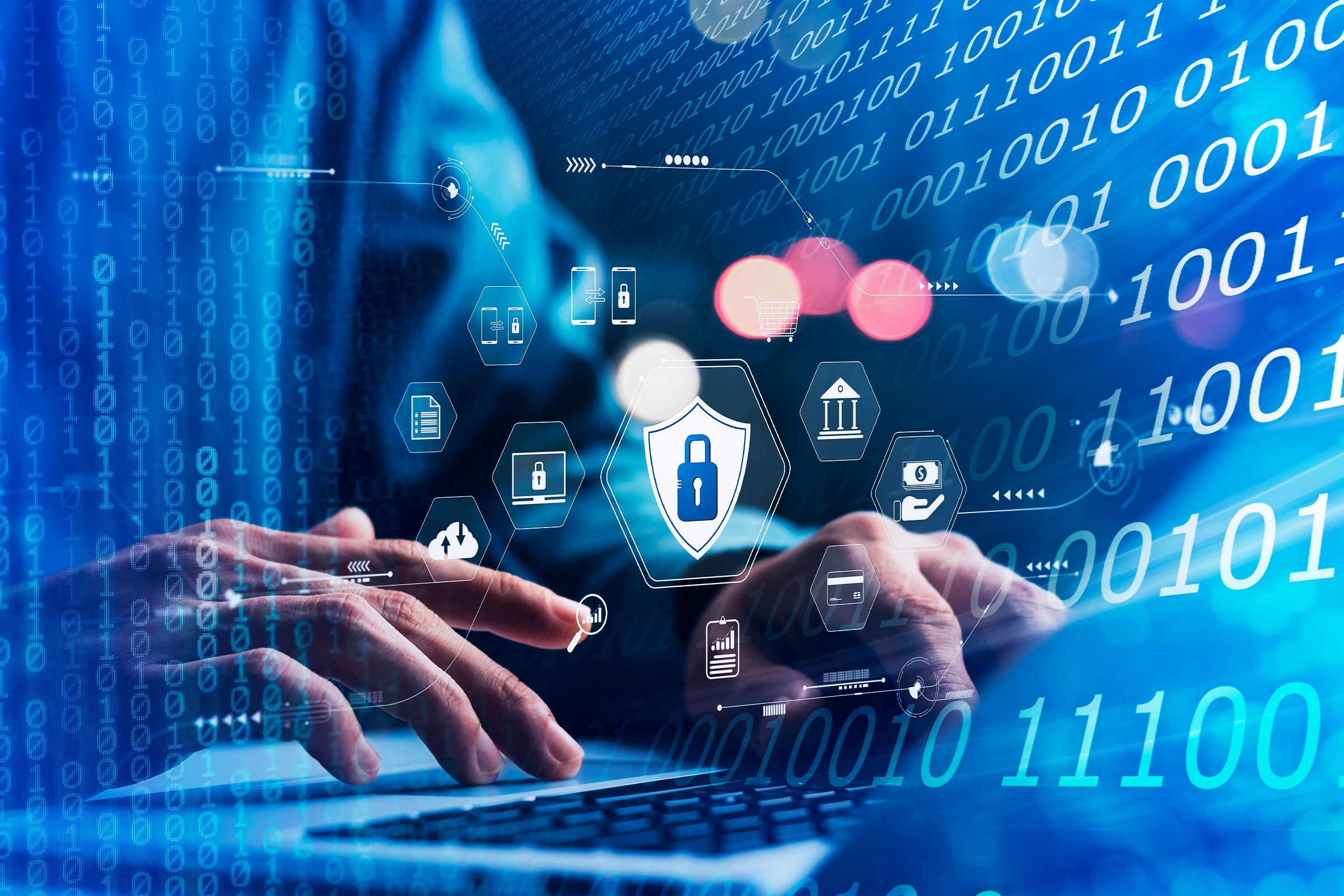 Рука за ноутбуком, вокруг иконки шифрования и двоичный код