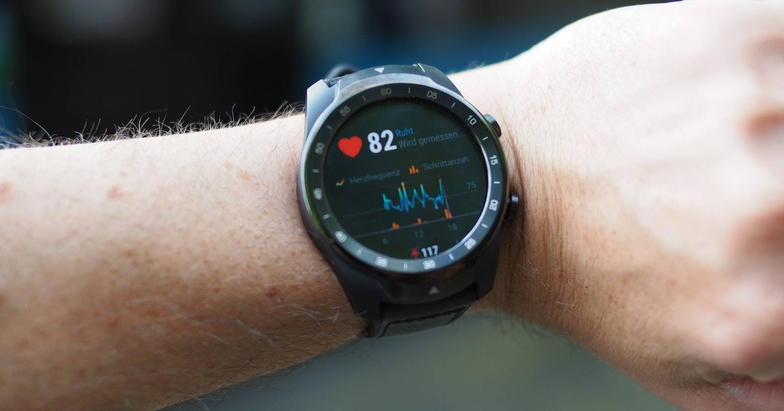 Person monitoring heart rate on a smartwatch