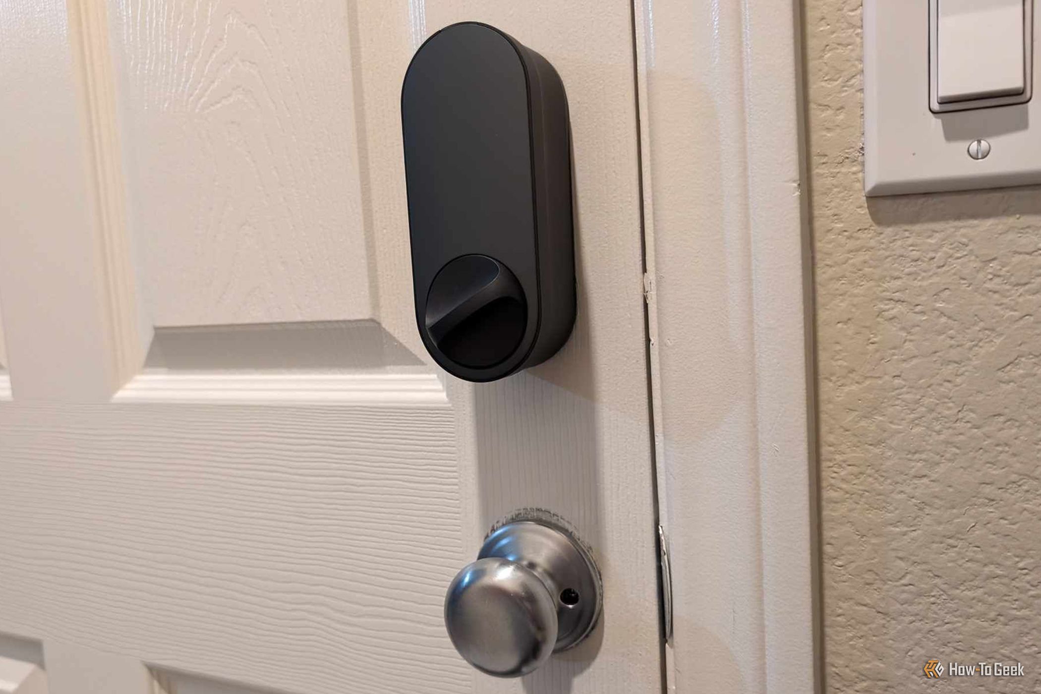 Black Aqara Smart Lock U200 installed on door and locked.
