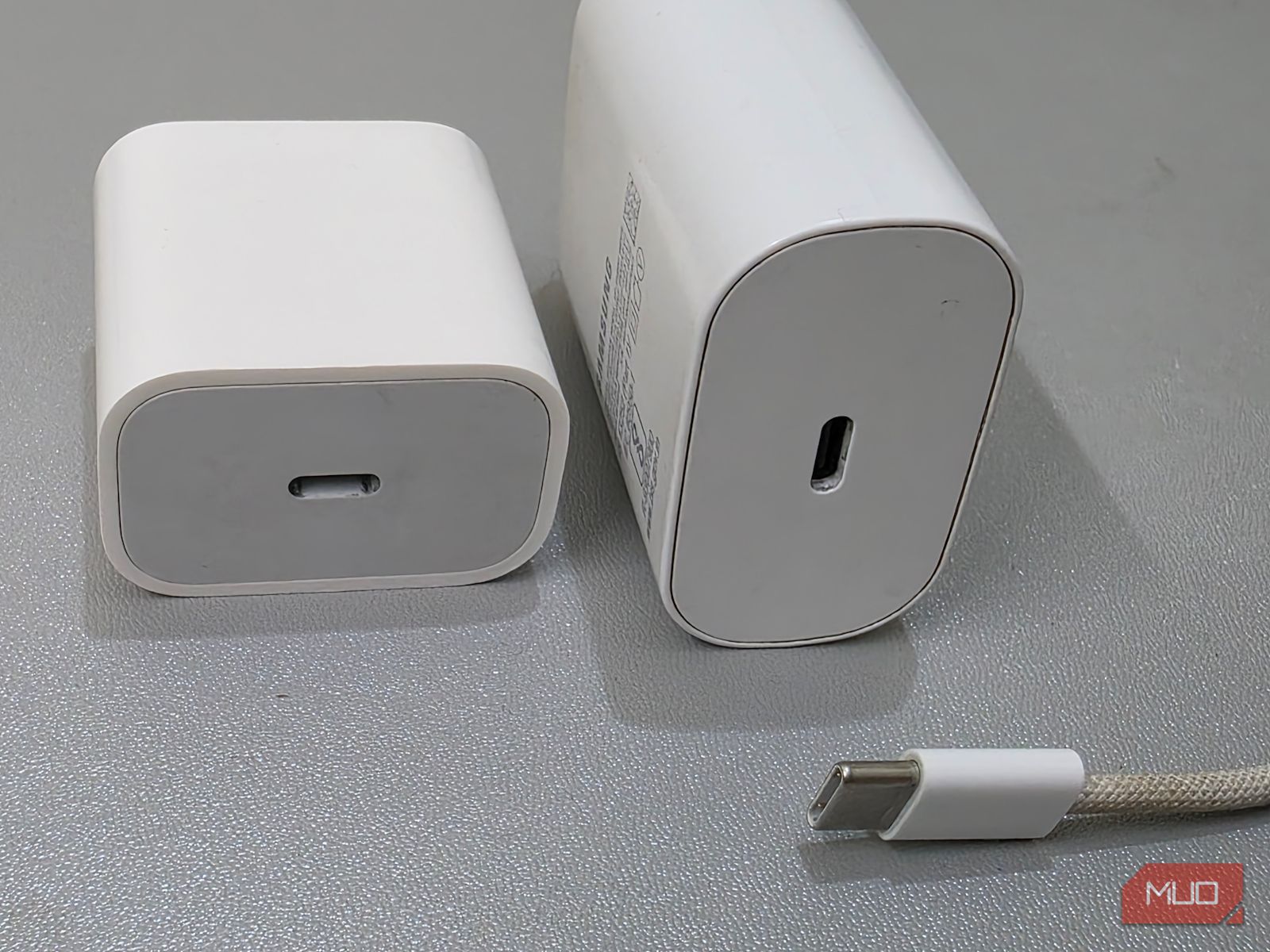 A charging cable and two adapters are placed together