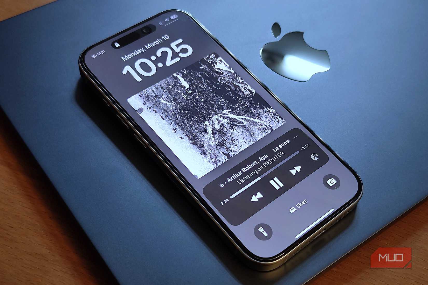 An iPhone 16 Pro set on a MacBook Air