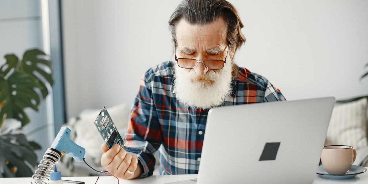man tryting to fix laptop