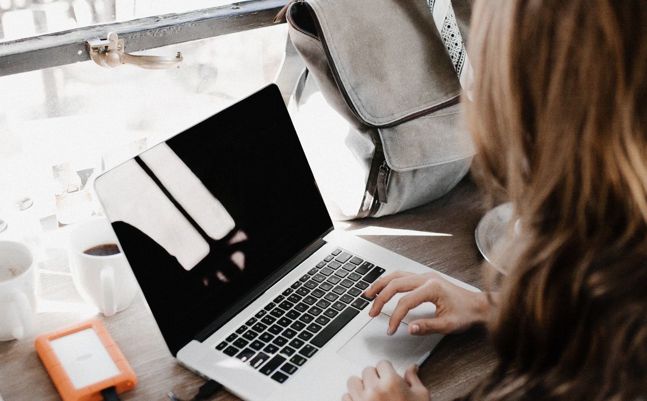 Seated woman using a MacBook