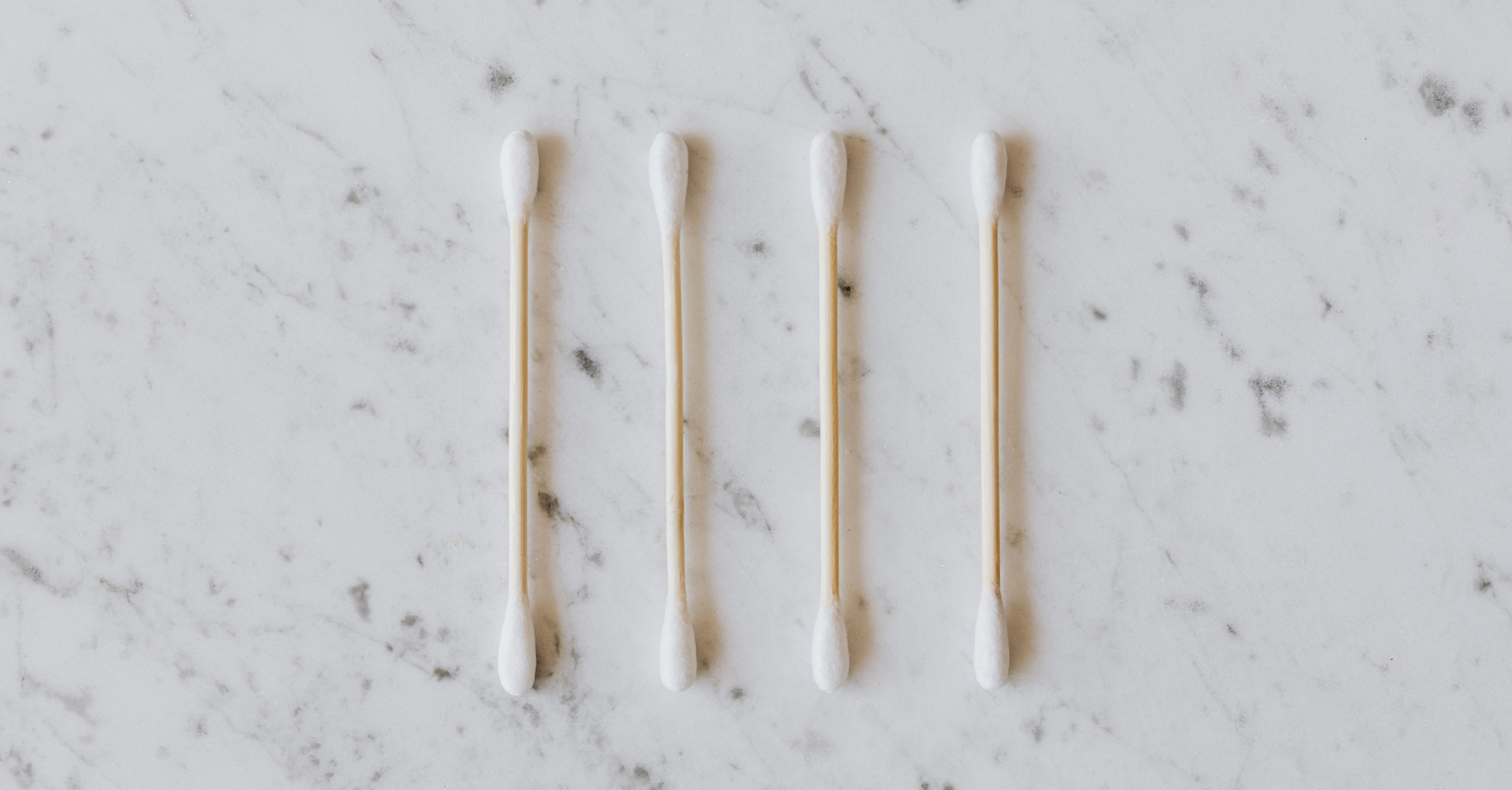 row of four cotton swabs