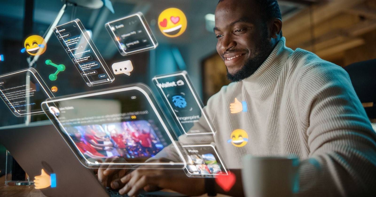 a man sitting in front of a laptop with projecting social media icons
