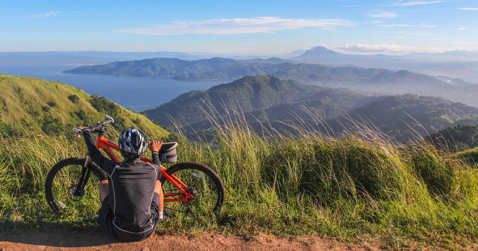 Man sitting beside his bike