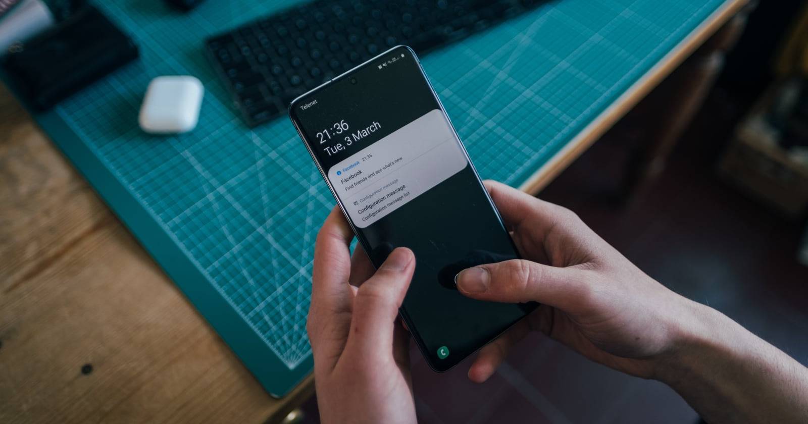 hands holding android phone