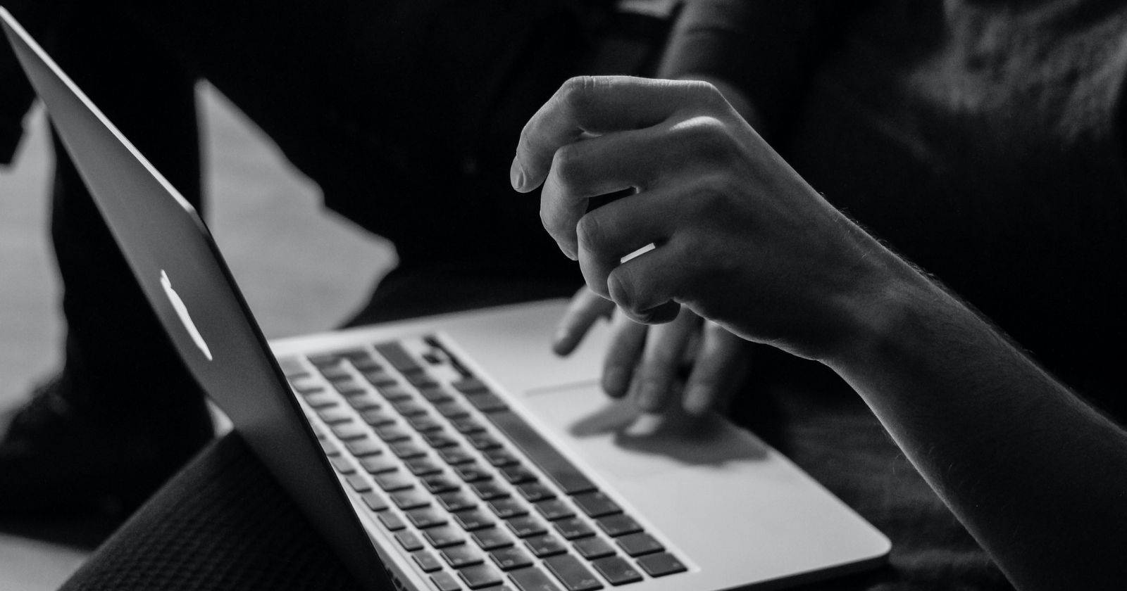 greyscale-photo-of-person-on-laptop
