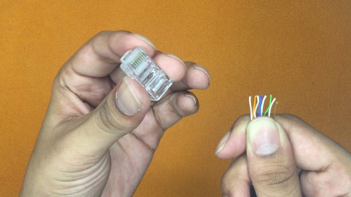 Straight through arrangement of Ethernet wires being inserted into a pass through connector