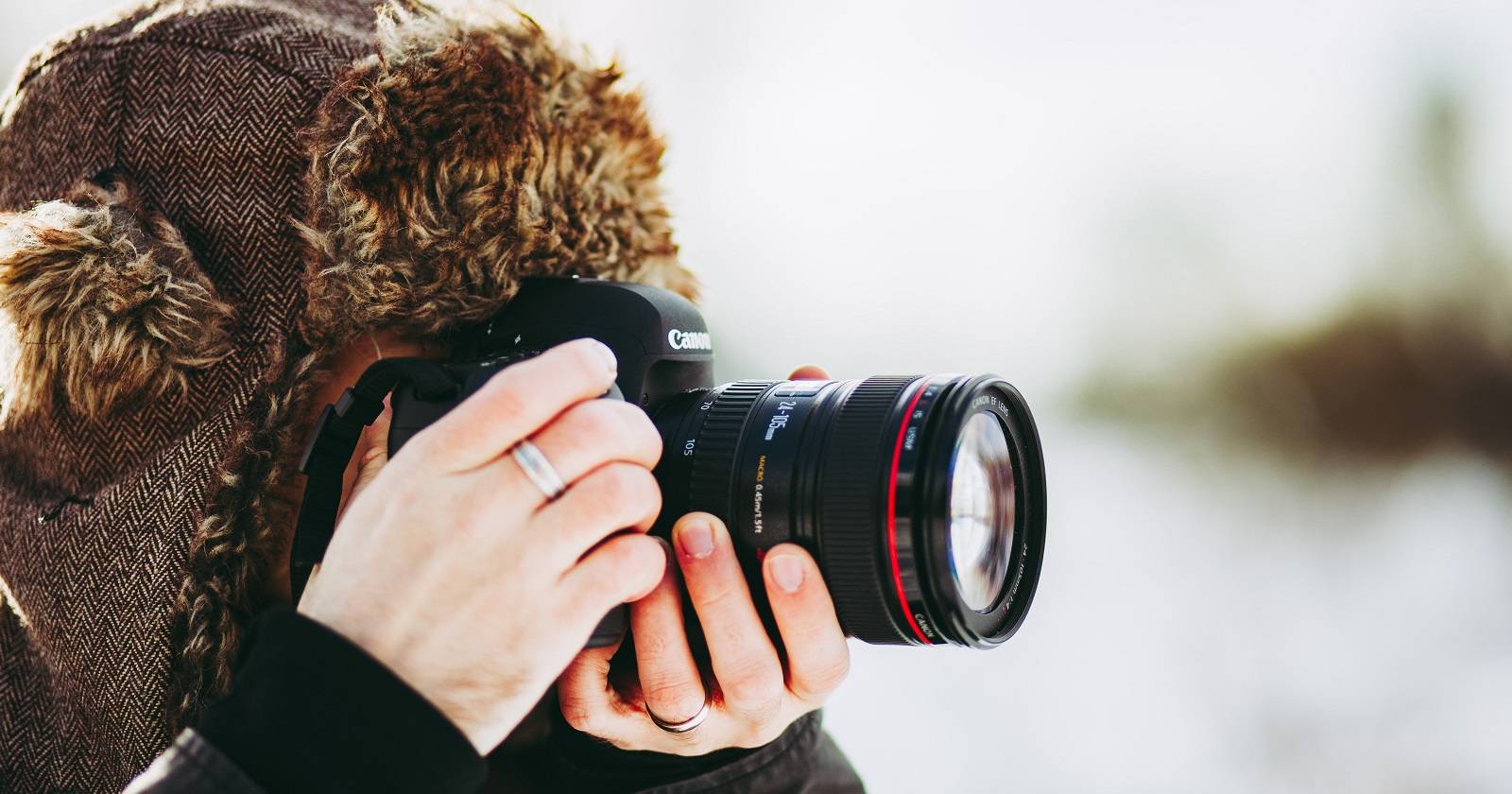 man-wearing-beanie-taking-pictures