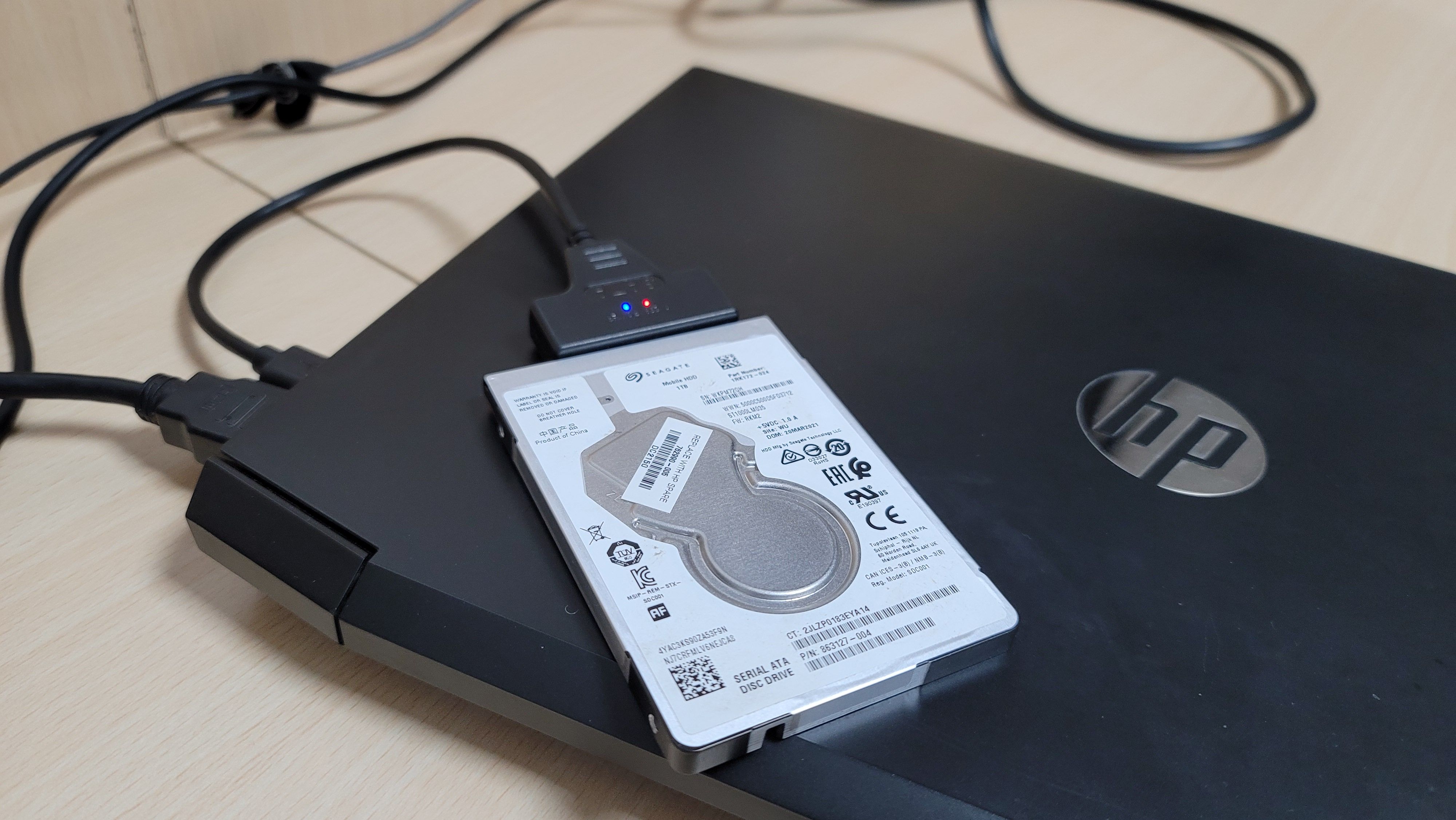 A SATA HDD connected to a HP Laptop via SATA-to-USB cable