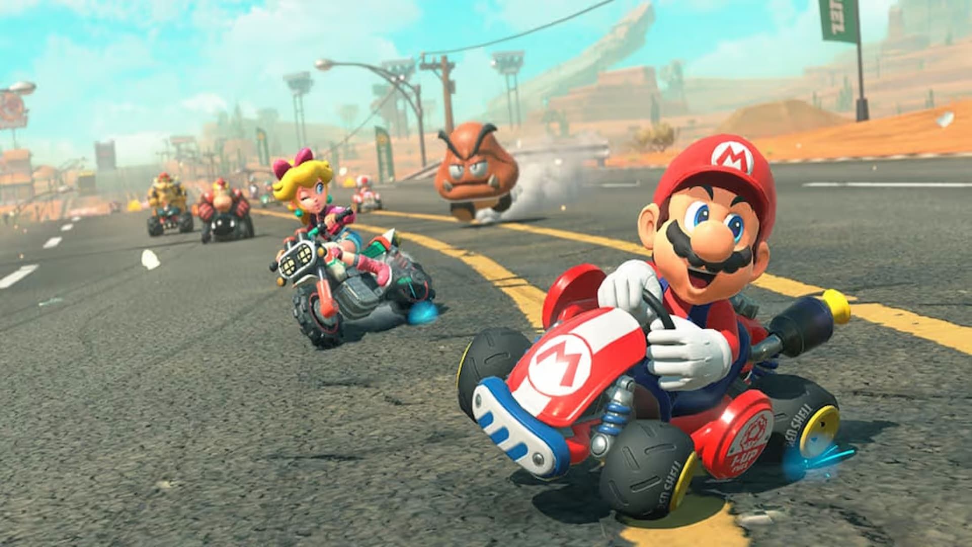 Mario and Princess Peach race away from a goomba in Mario Kart World.