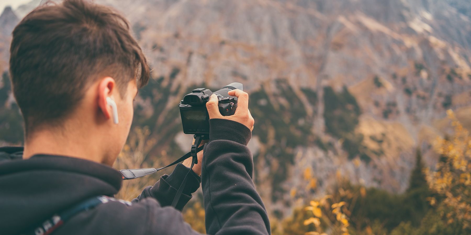 Young man photographing landscape