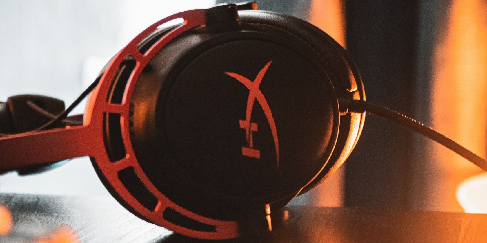 Red and Black Gaming Headset Resting on Desk