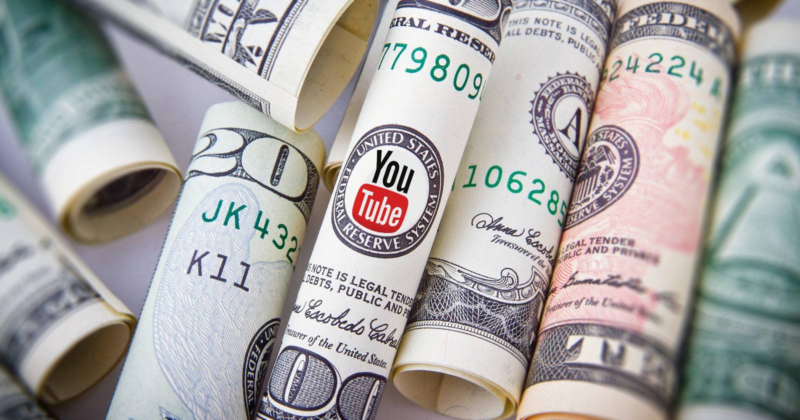 Деньги и логотип YouTube как символ монетизации
