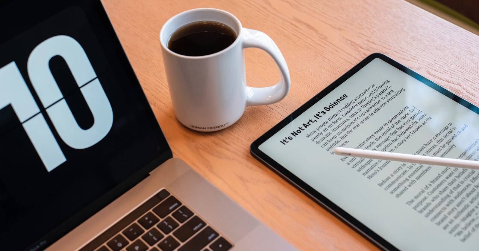 a laptop, tablet, and a cup of coffee