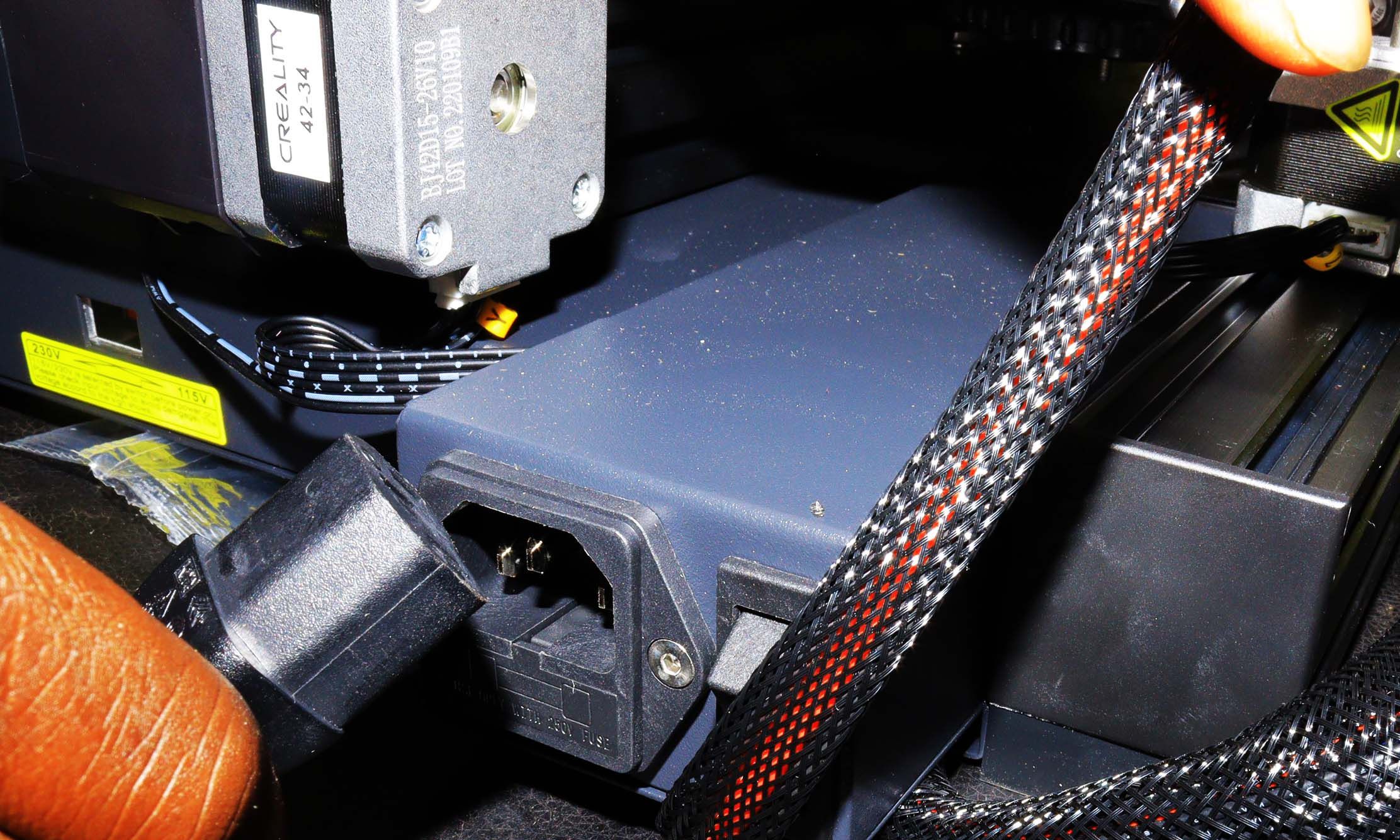 Unplugging the power cord from the power supply of Ender 3 V2