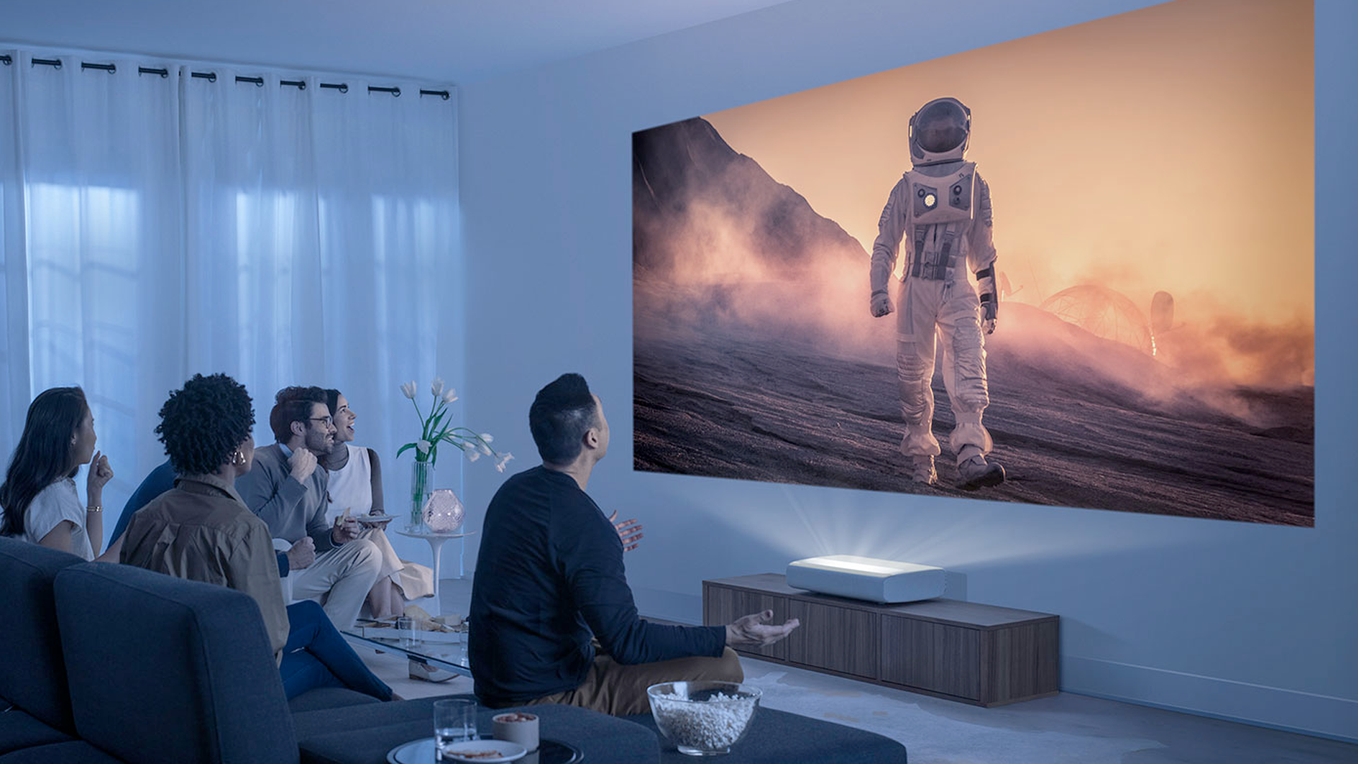 People watching a film with the Samsung Premiere projector.