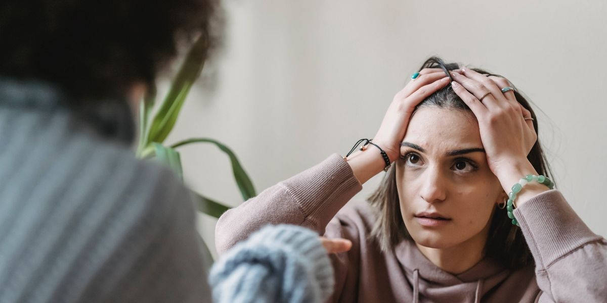 Anxious/frustrated woman touching her head