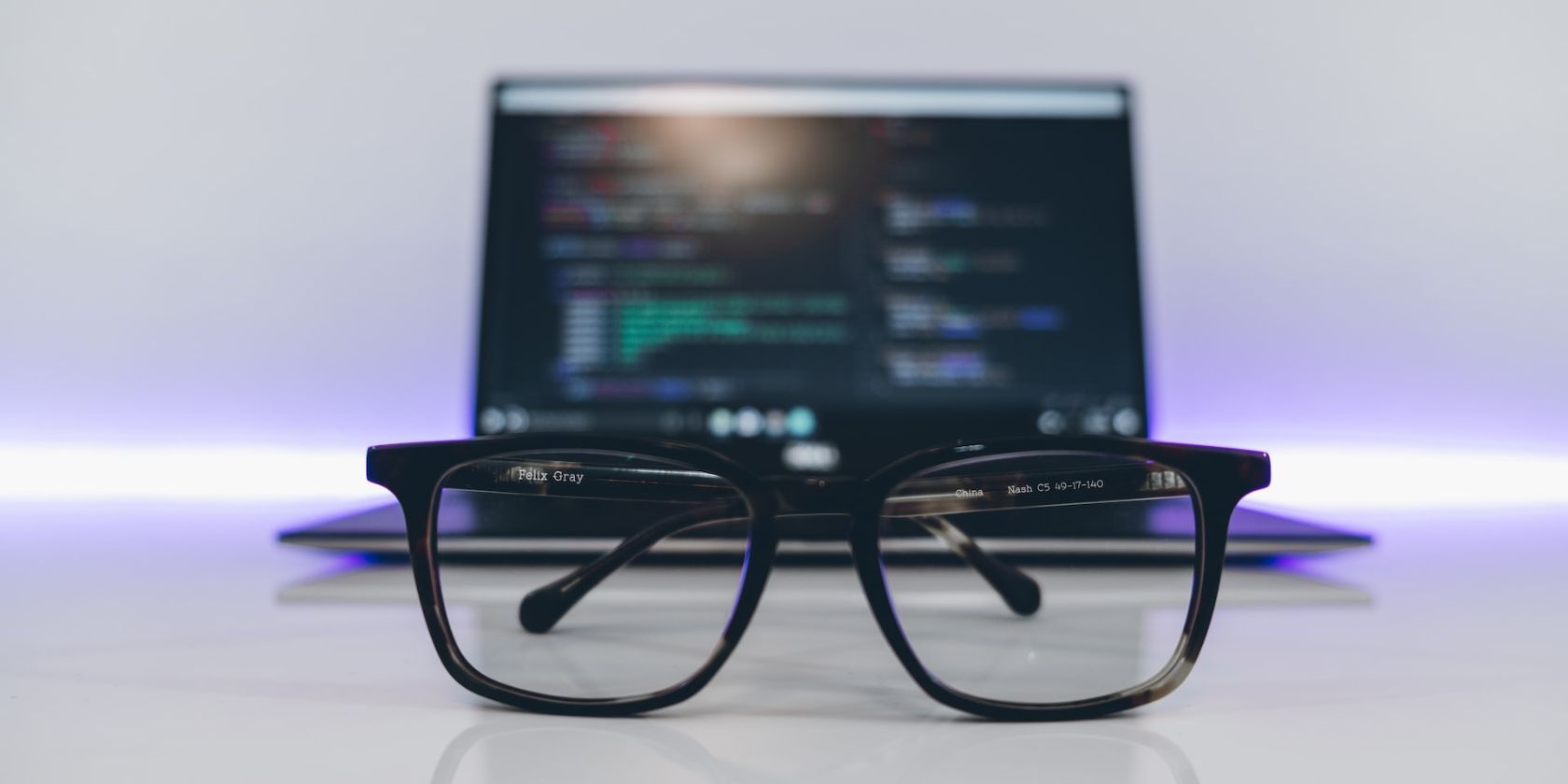 Очки на столе рядом с ноутбуком