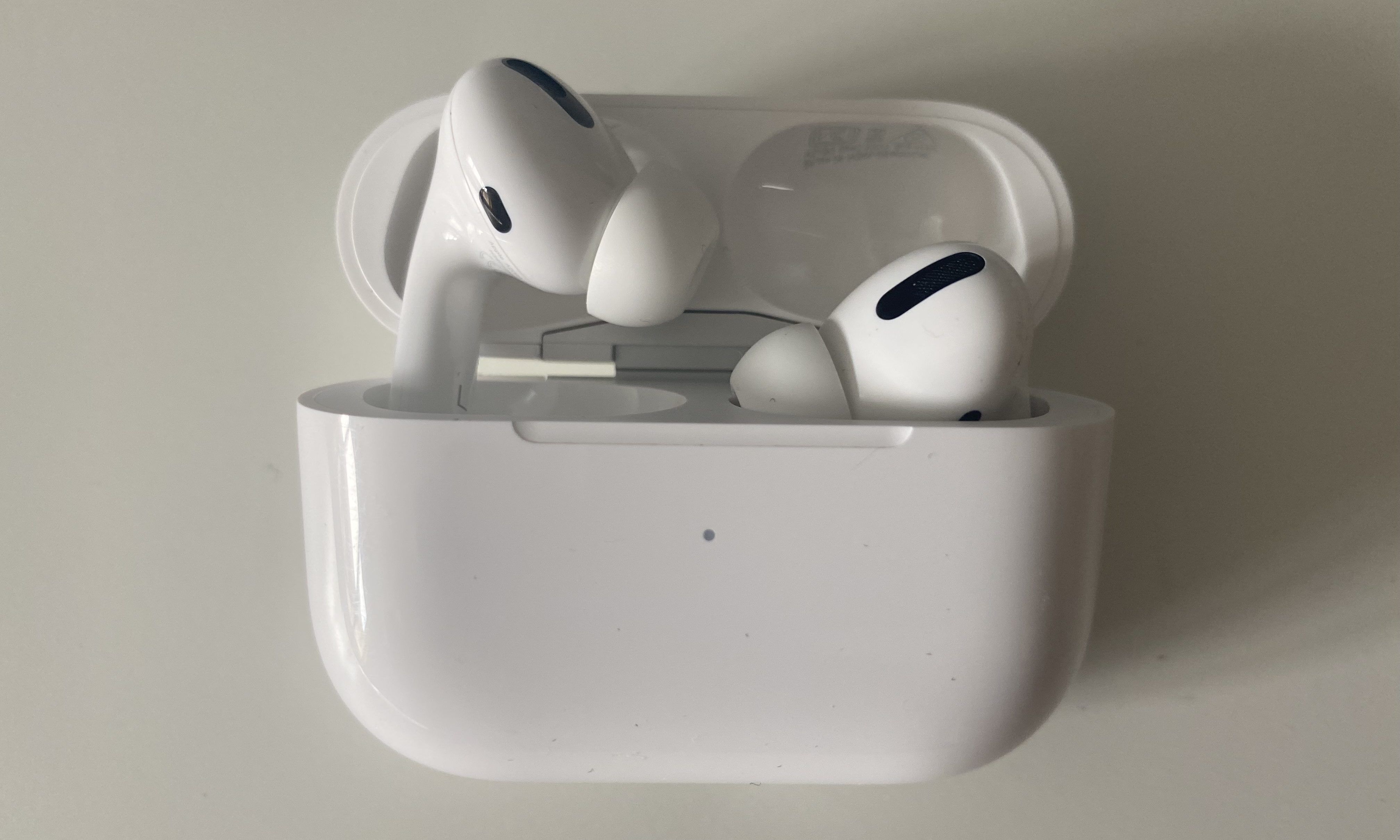 Sliding AirPods into the charging case.