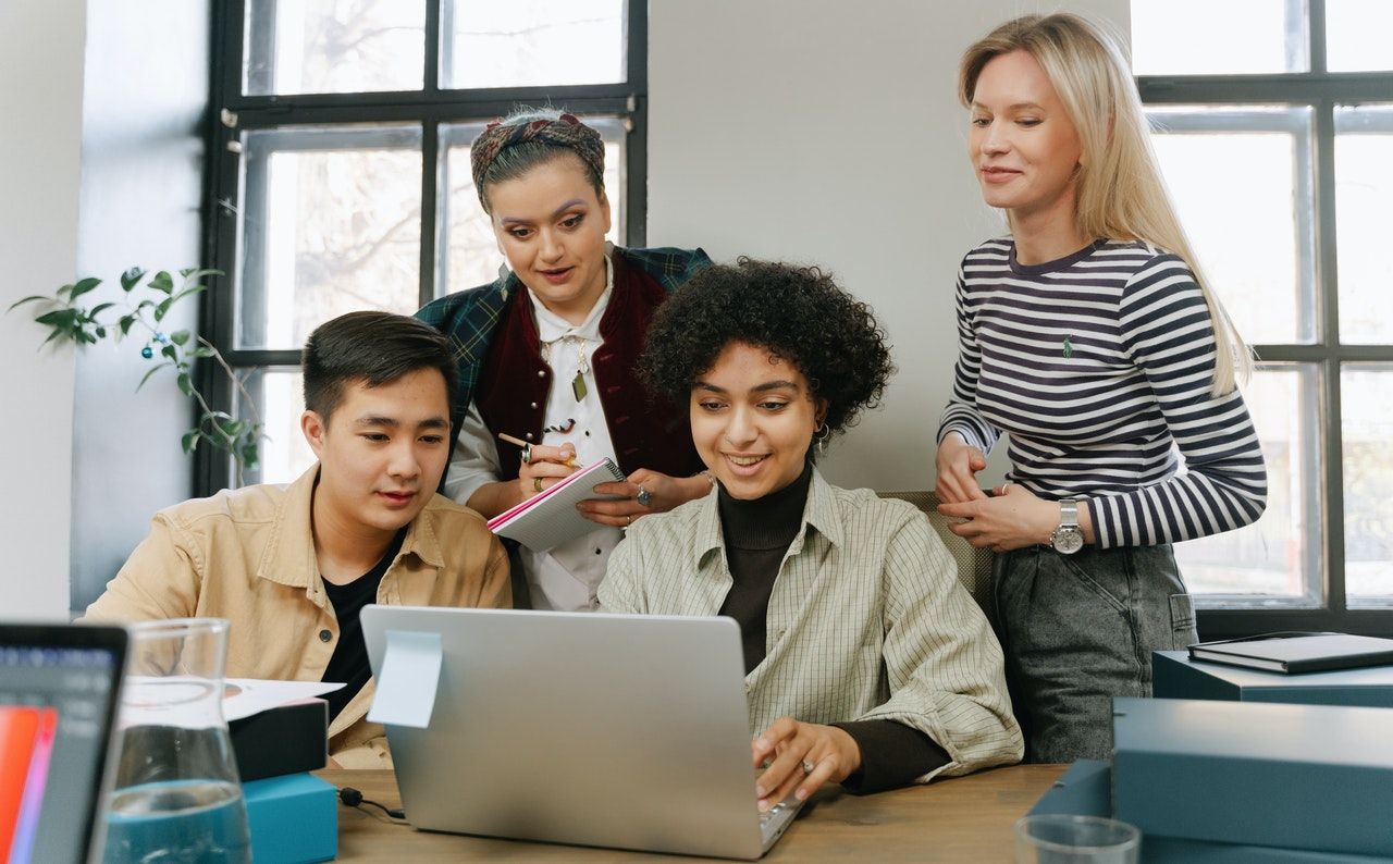 Young people looking at a laptop