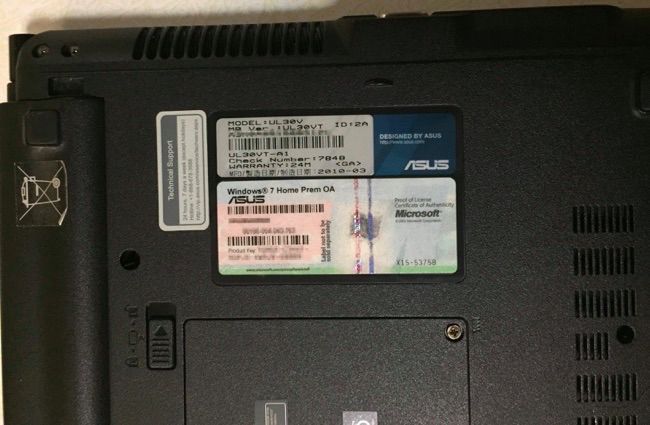 The bottom of a laptop showing a Windows 7 license key.