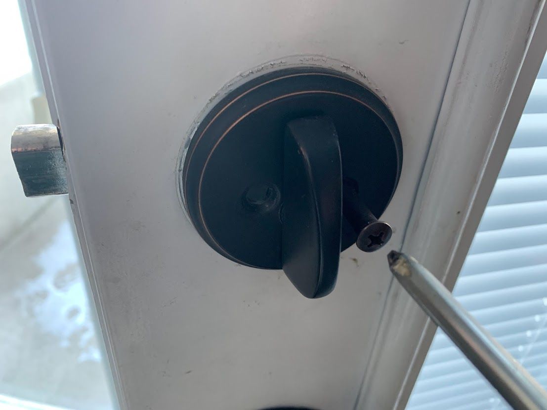 Unscrew old deadbolt