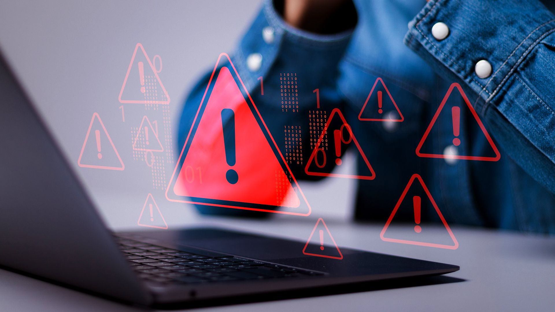 data breach on laptop with warning red triangles