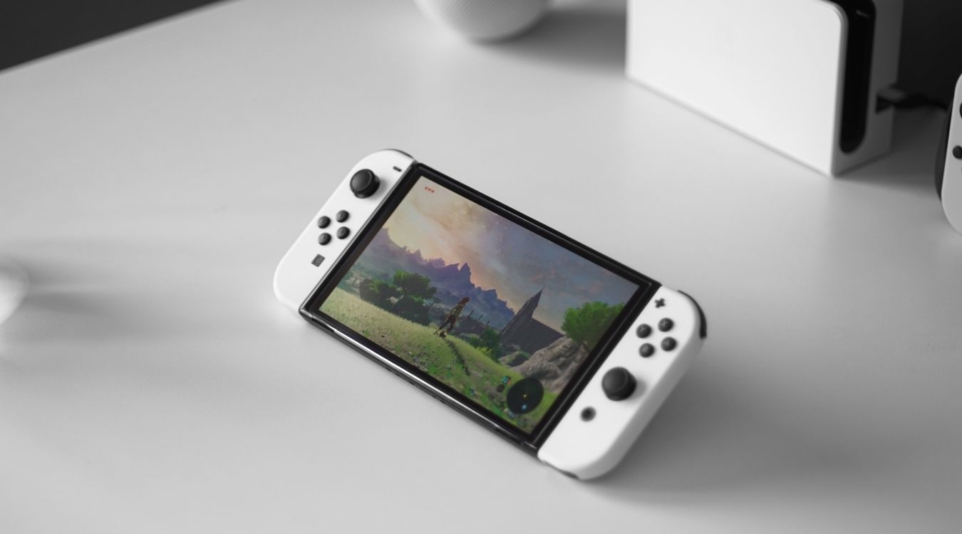 A photograph fo a Nintendo Switch OLED console in handheld mode