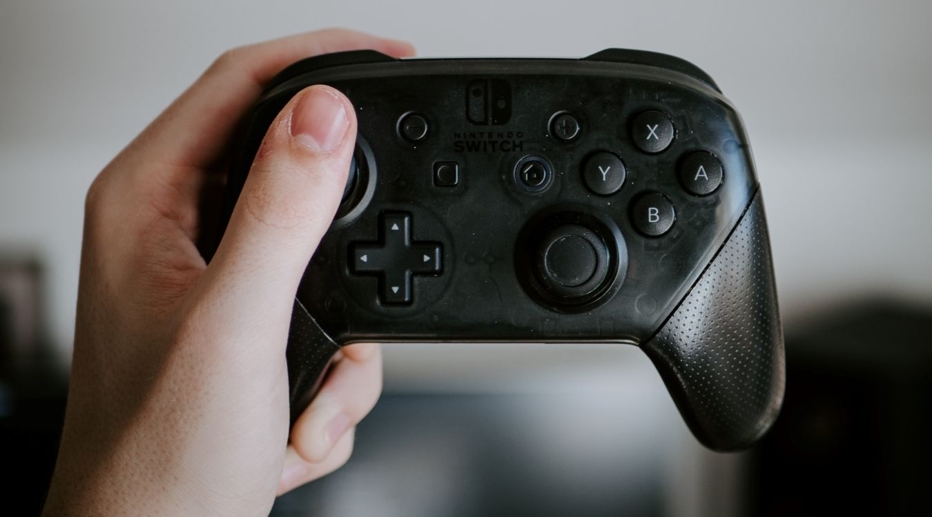 A photograph of a black Nintendo Switch Pro Controller