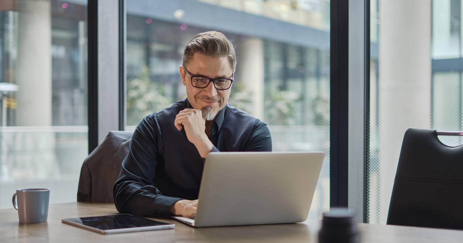 Мужчина работает за ноутбуком в офисном здании