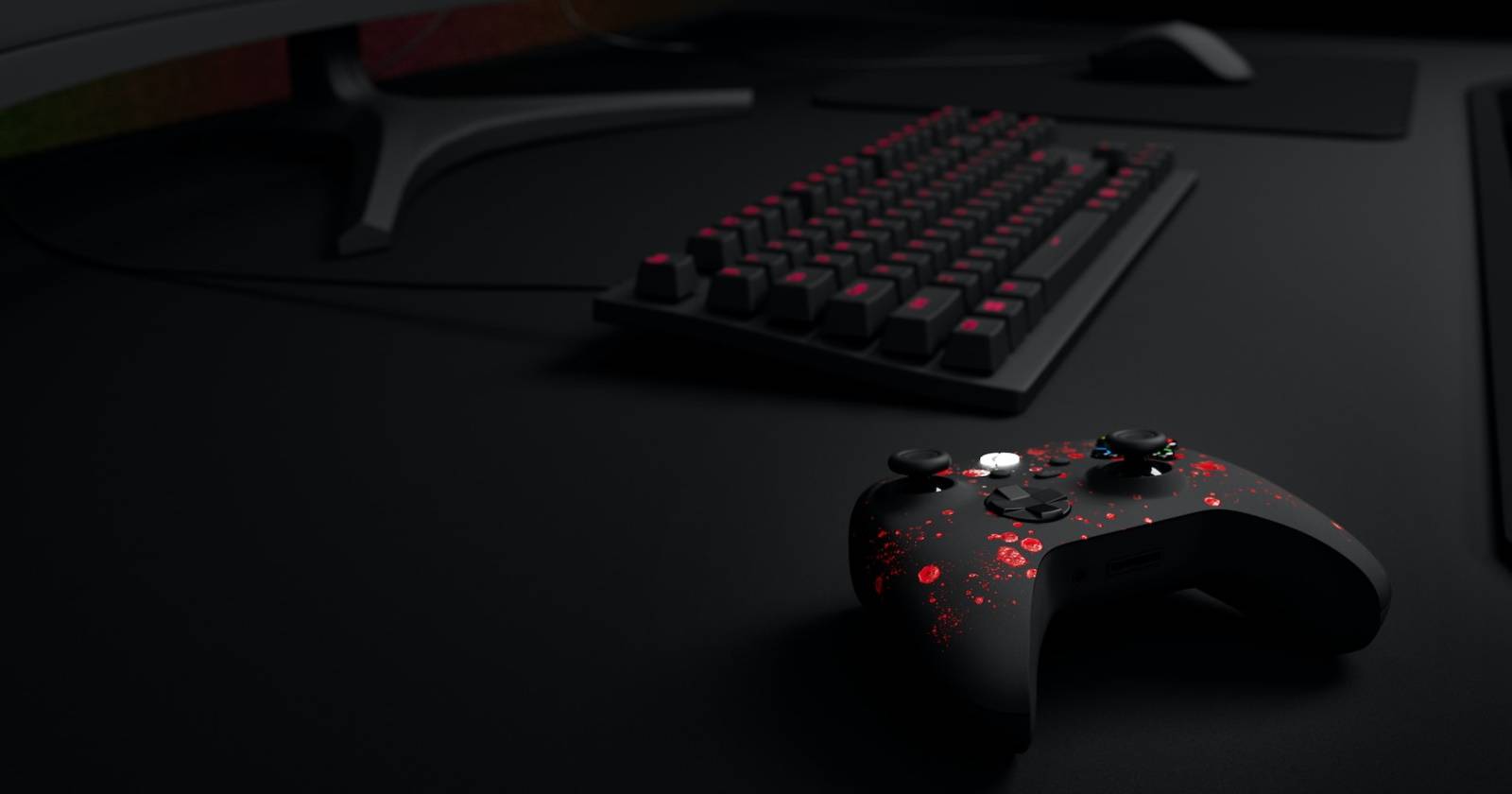 机の上のコントローラーとキーボードの写真