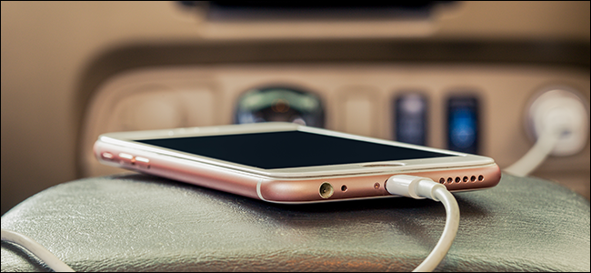 An iPhone charging in a car