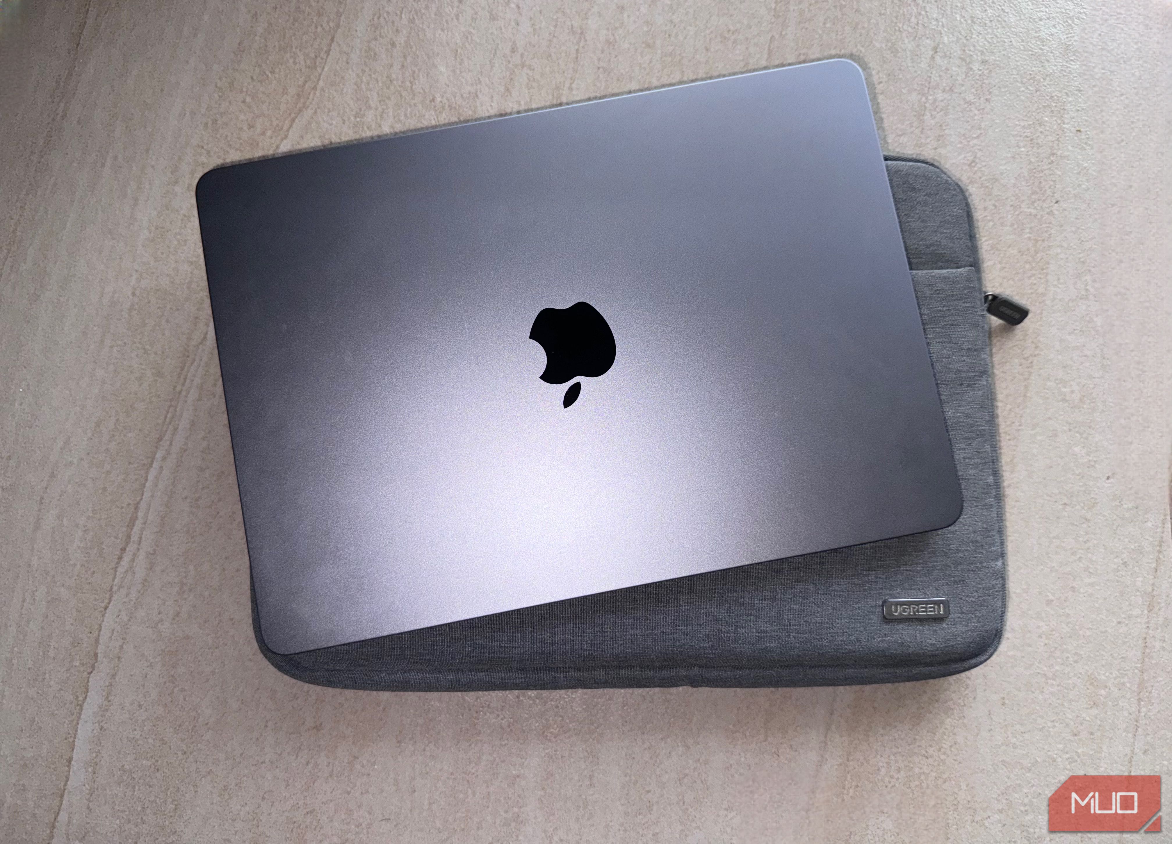 MacBook and a Ugreen sleeve on a flat surface.