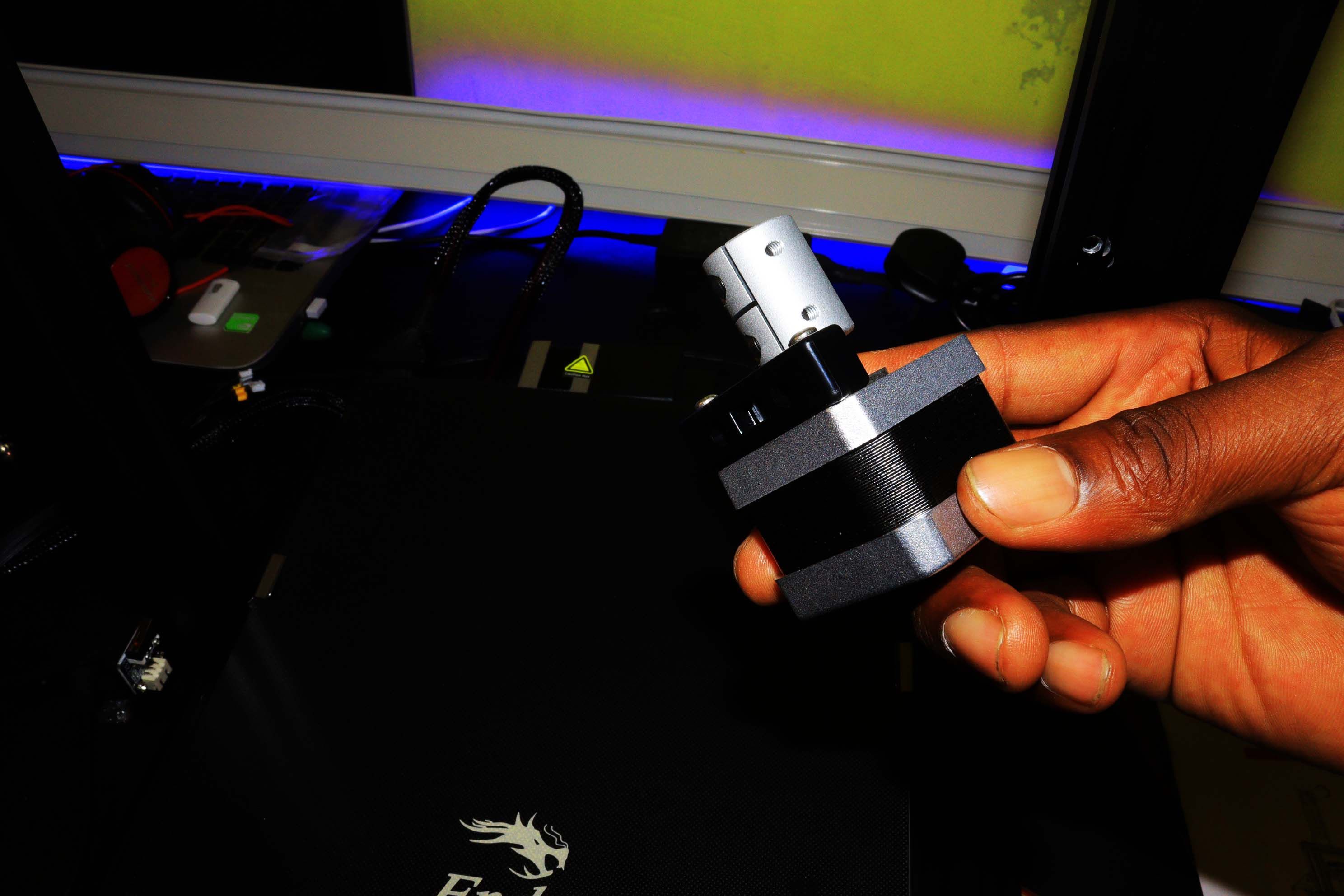 A hand holding a Z-axis motor
